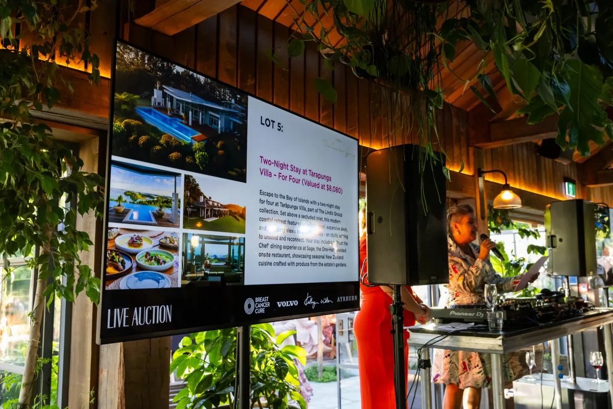86 inch TV on a stand running live auction slides at Ayrburn - TV hire Christchurch, AV production NZ
